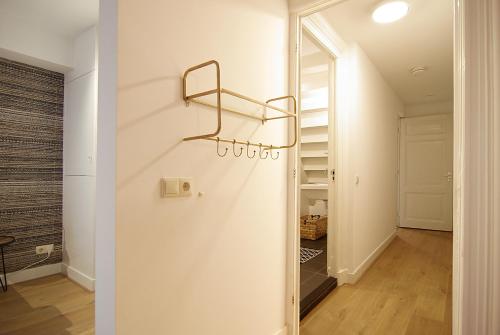 a hallway with a walk in closet and a glass door at Luxury Leidseplein with Private Patio in Amsterdam