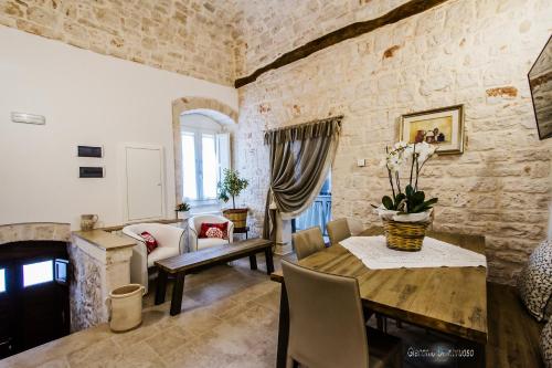 a living room with a table and a couch at Borgo Noci in Noci