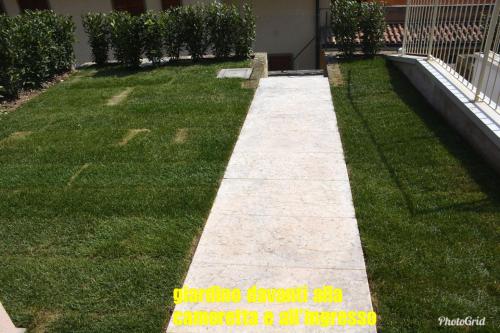 a walkway in the grass next to a house at Dream Apartment in Toscolano Maderno
