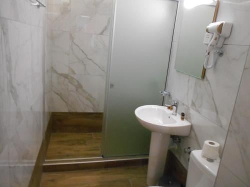 a bathroom with a sink and a shower at Artemis Hotel Apartments in Hersonissos
