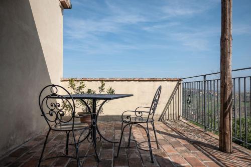 a table and chairs on a balcony with a view at Il Castellaro in Borghi