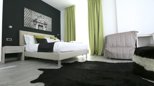 a bedroom with a white bed and a chair at Ecumano Space in Naples