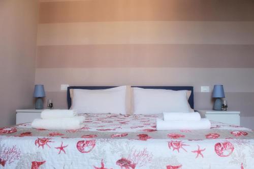 a bedroom with a bed with pillows on it at Villa Carina in Massa