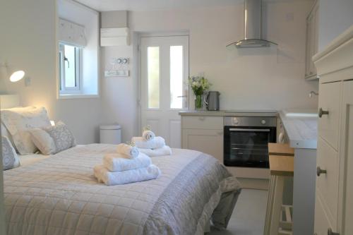 a bedroom with a bed with towels on it at Ashford house 'The Snug' private hot tub in Fylingthorpe
