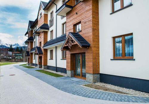 a row of buildings on a street at Apartamenty Forma Tatrica in Zakopane