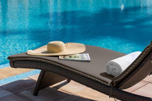 a hat sitting on a chair next to a swimming pool at Blue Flamingo Resort Key West in Key West