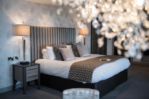 a bedroom with a bed and a christmas tree at Hetland Hall Hotel in Dumfries