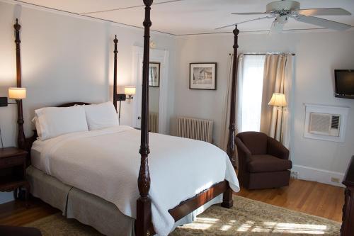 a bedroom with a large bed and a chair at Camden Windward House in Camden