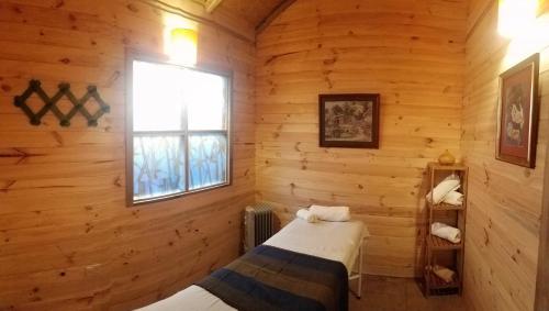 a bedroom with two beds in a log cabin at Hacienda El Porvenir by Tierra del Volcan in Machachi