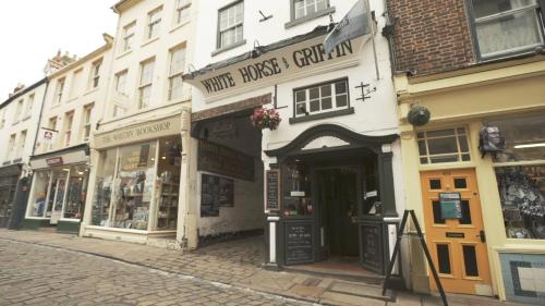 a building with a store on a street at White Horse & Griffin in Whitby