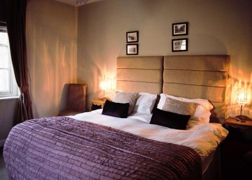 a bedroom with a large bed with two pillows at White Horse & Griffin in Whitby