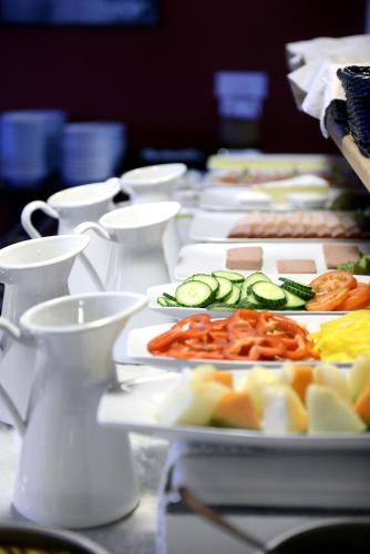 a row of plates of food on a table at Good Morning Karlstad City in Karlstad