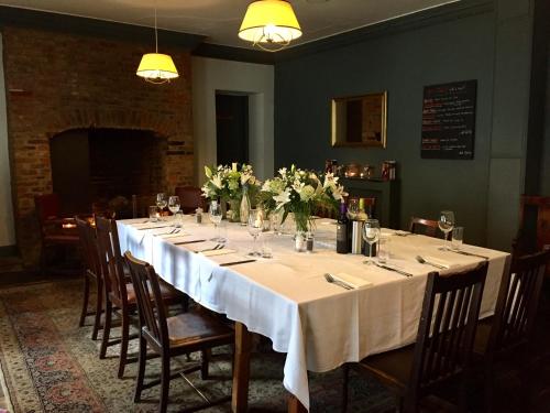 a long table with white table cloth and flowers on it at White Horse & Griffin in Whitby