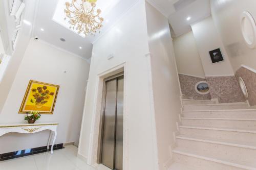 a staircase in a house with a chandelier at Hotel Belagrita in Berat