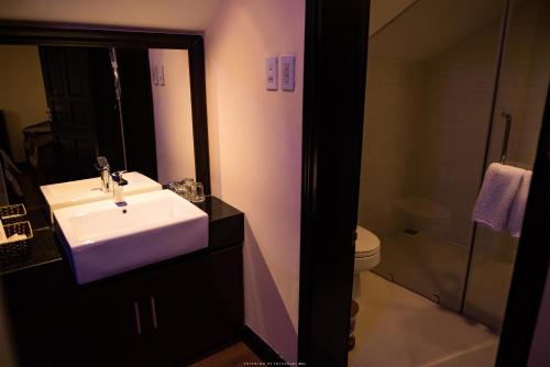 a bathroom with a white sink and a toilet at Spring Garden Villa in Hue