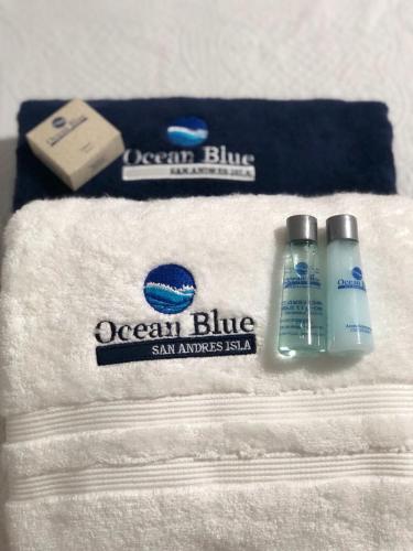 a towel with a bottle of ocean blue and a soap at Ocean Blue Beach in San Andrés