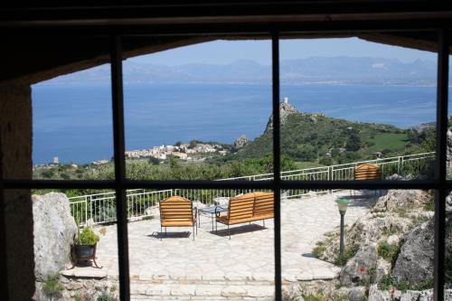a view from a window of a patio with chairs at Casale Corcella in Scopello
