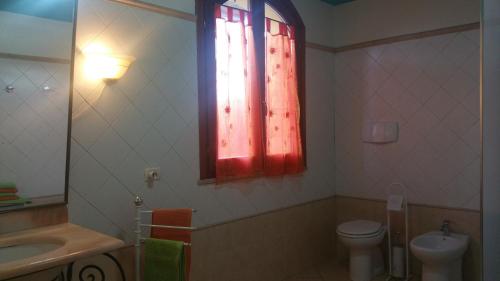 a bathroom with a sink and a toilet and a window at Il Sogno di Alghero - Adults Only in Alghero