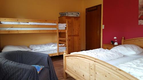 a bedroom with two bunk beds and a chair at Wohnung 1 mit überdachte Terrasse zum Garten Nähe Strand und Hafen Bensersiel in Bensersiel
