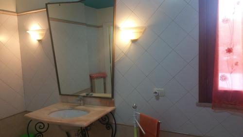 a bathroom with a sink and a mirror at Il Sogno di Alghero - Adults Only in Alghero