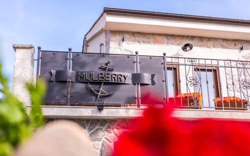 a building with a sign that reads mulberry at Villa Mulberry in Krk