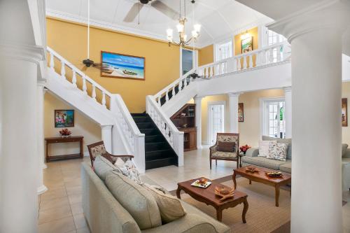 a living room with a staircase and a couch at Half Moon in Montego Bay