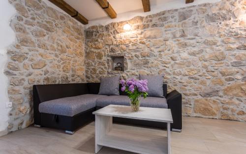 a living room with a couch and a table at Villa Mulberry in Krk