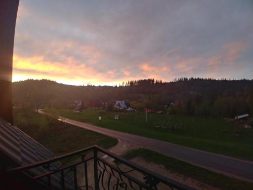 a view from a balcony of a road at sunset at Willa Pawlikowskich in Poronin