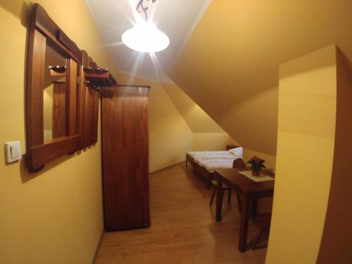 a room with a table and a light on a ceiling at Willa Pawlikowskich in Poronin
