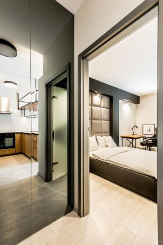 a bedroom with a bed and a sliding glass door at Super-Apartamenty Exclusive in Poznań