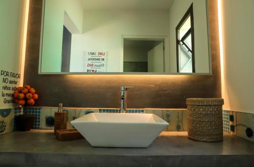 a bathroom with a white sink and a mirror at Terralagum in Villa Parque Siquiman