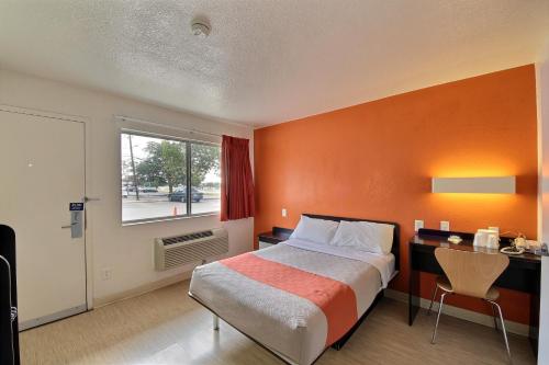 a bedroom with a bed and a desk and a window at Motel 6-San Marcos, TX in San Marcos