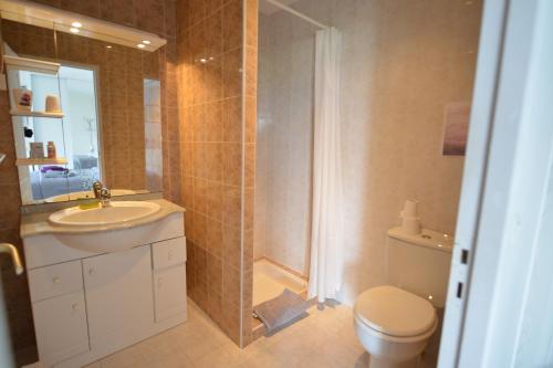 a bathroom with a toilet and a sink and a shower at Maison Margot in Vallauris