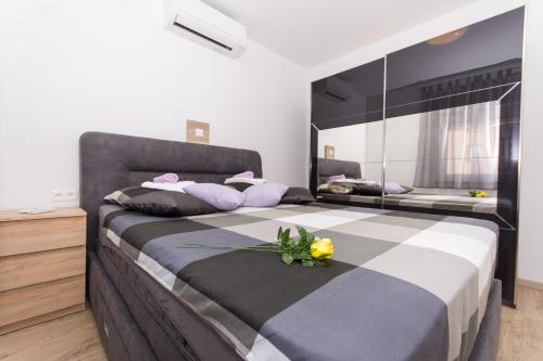a bedroom with a large bed with flowers on it at Villa Initium,heated pool all season in Trogir