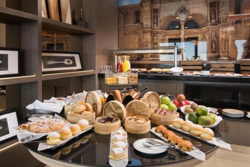a buffet with many different types of food on a table at El Embajador, a Royal Hideaway Hotel in Santo Domingo