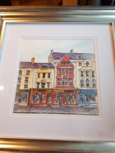 a painting of a building in a city at The Square townhouse Fermoy in Fermoy