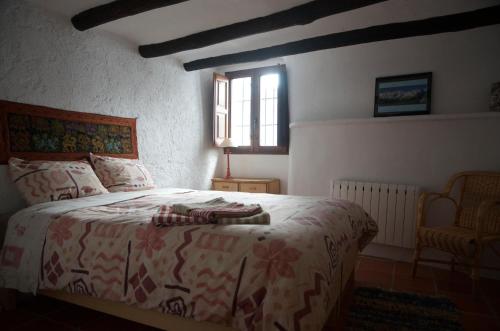 a bedroom with a bed and a window at Casa Josefa in Capileira