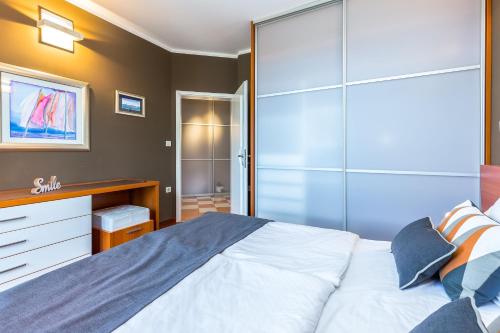 a bedroom with a large bed and a closet at Villa Nada in Lovran