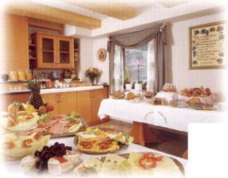 a kitchen with many plates of food on a counter at Hotel Gasthof Hirsch in Alfdorf