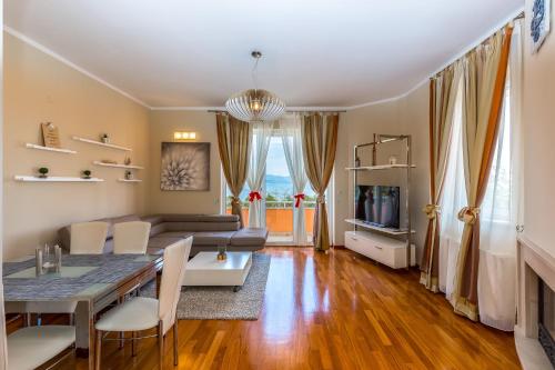 a living room with a table and a couch at Villa Nada in Lovran