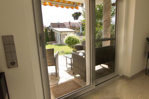 an open door to a patio with a table and chairs at Rust-Fewo-Hotel in Rust