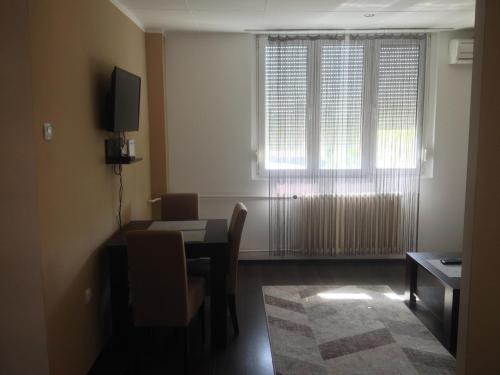a living room with a dining table and a window at Markoni in Pančevo