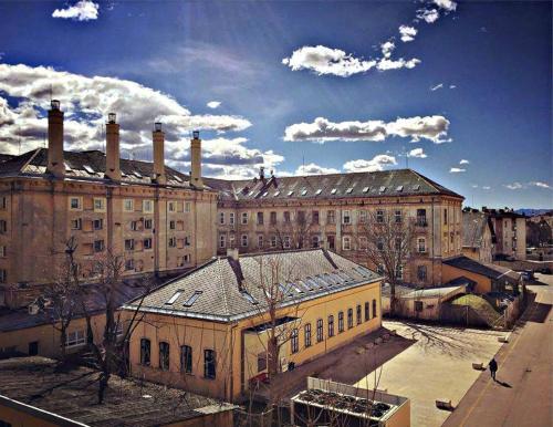 a large building with several chimneys on top of it at The Maze Apartment in Ljubljana