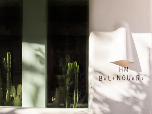 a white lamp sitting next to a cactus at HM Balanguera in Palma de Mallorca