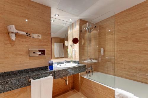 a bathroom with a sink and a shower at Senator Barajas in Madrid