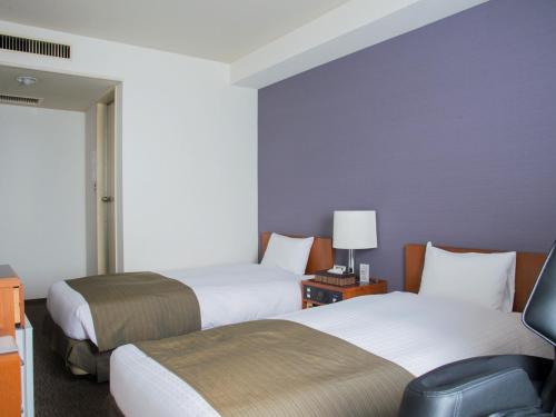 Un pat sau paturi într-o cameră la Hotel Abest Nagano Ekimae