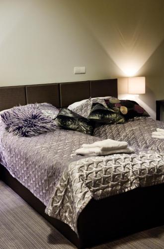 a bed in a bedroom with two people laying on it at Rezydencja Eger in Kazimierz Dolny