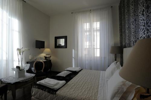 En eller flere senge i et værelse på Luxury B&B La Dimora Degli Angeli