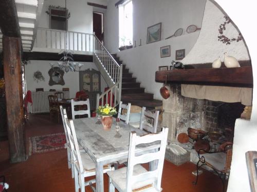 a dining room with a table and chairs and a staircase at Mas Les Micocouliers in Saint-Christol-lès-Alès