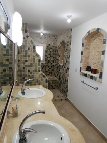 a bathroom with two sinks and a shower at Luxury apartment with ocean view at the beach in Cabarete